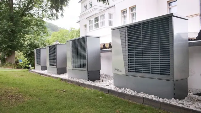 Row of heat pumps outside a building promoting sustainable energy solutions. Cold-climate heat pump rebates in Ontario: what the Canada Greener Homes Loan covers
